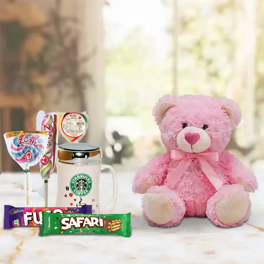 Candies, chocolates, a Starbucks coffee mug, and a 6-inch teddy bear arranged as a cheerful New Year gift set.