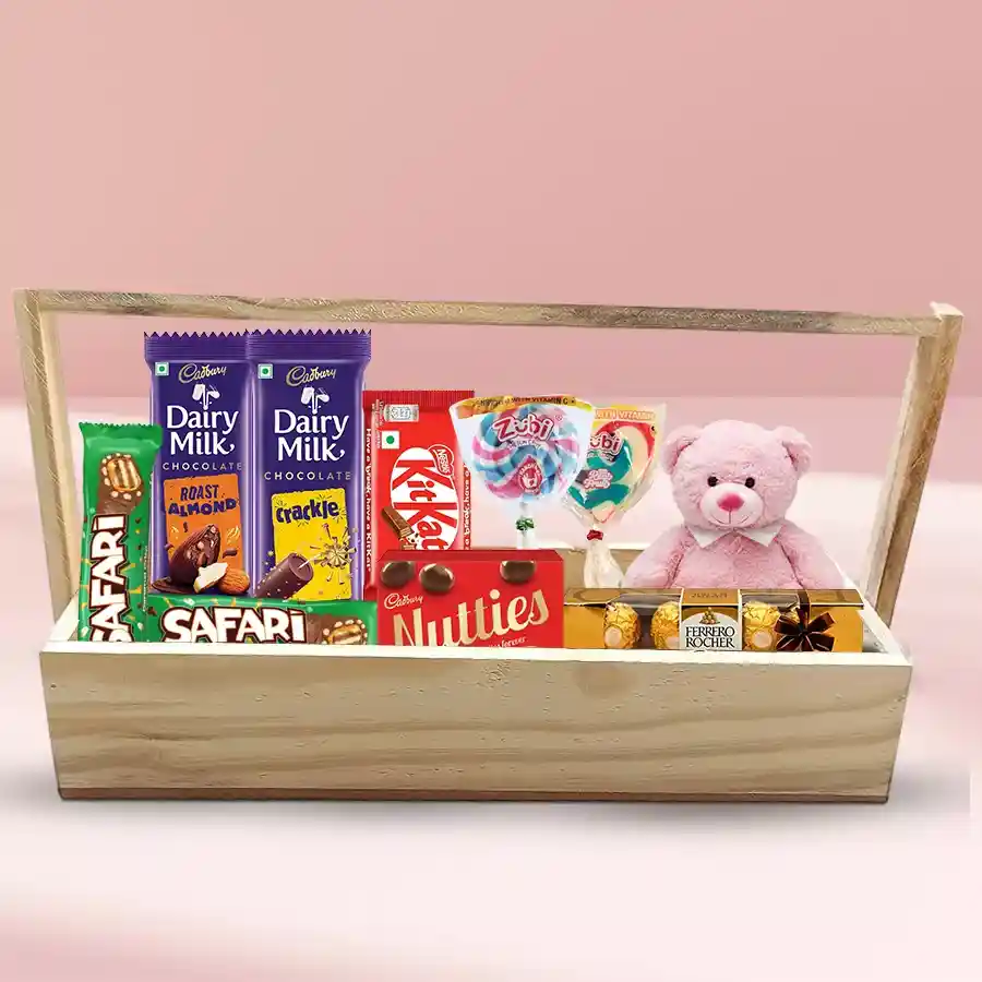 Delicious Happy New Year gift hamper featuring a 6-inch teddy, assorted chocolates, and a personalized 2-line SMS on a wooden tray.