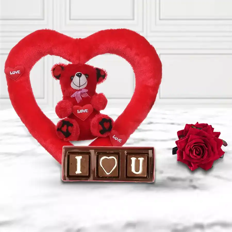 Incomparable Teddy Bear and Chocolates for Valentine's Day featuring a 25 cm teddy bear, three homemade "I Love You" chocolates, and a velvet red rose on a heart-shaped cushion