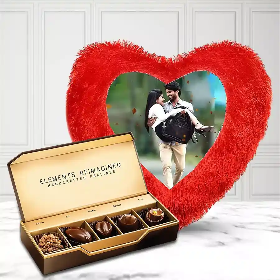 Heart shaped personalized cushion alongside a box of five ITC chocolates, designed for Mother's Day gifting.