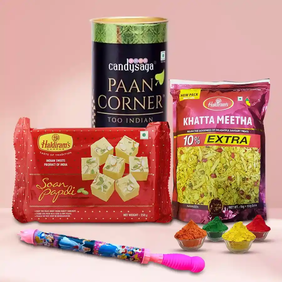Perfect Holi Gift Hamper featuring Haldiram’s Soan Papdi, Khata Meetha Mixture, Paan Chocolates, vibrant Herbal Gulal, and a Pichkari