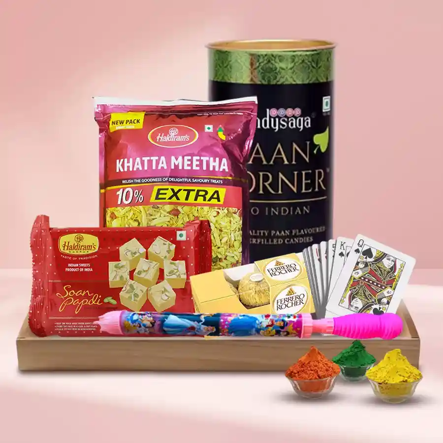 Pleasing Holi Gifts Hamper including traditional sweets, chocolates, playing cards, herbal gulal, and a free pichkari in a wooden tray