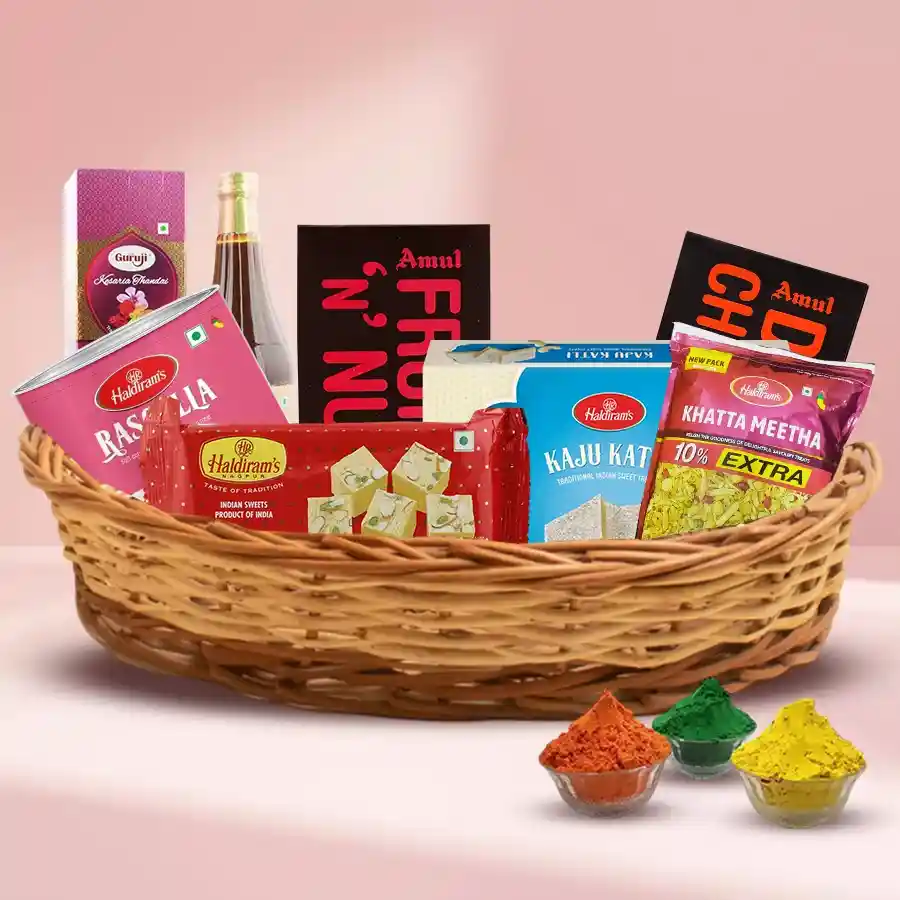 Exciting Sweet n Sour Holi Gifts Basket with Haldirams sweets, Amul chocolates, Kesar Thandai, and herbal gulal arranged in a cane basket