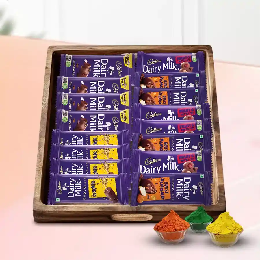 Cadbury Holi Gift Hamper featuring chocolates and vibrant herbal gulal in a wooden tray