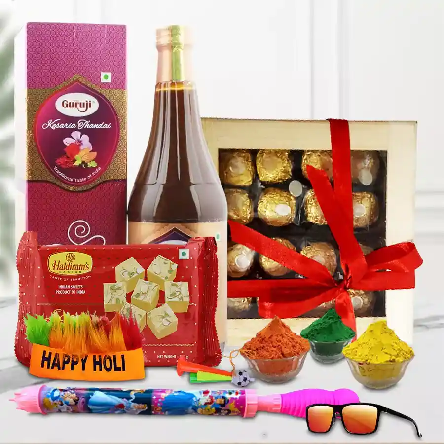 Holi gift box featuring Ferrero Rocher chocolates, Haldirams Soan Papdi, Gurujis Kesar Thandai, herbal gulal, a pichkari water gun, Holi confetti, a whistle, a cap, and trendy eye glasses, all arranged in a beautiful wooden box.