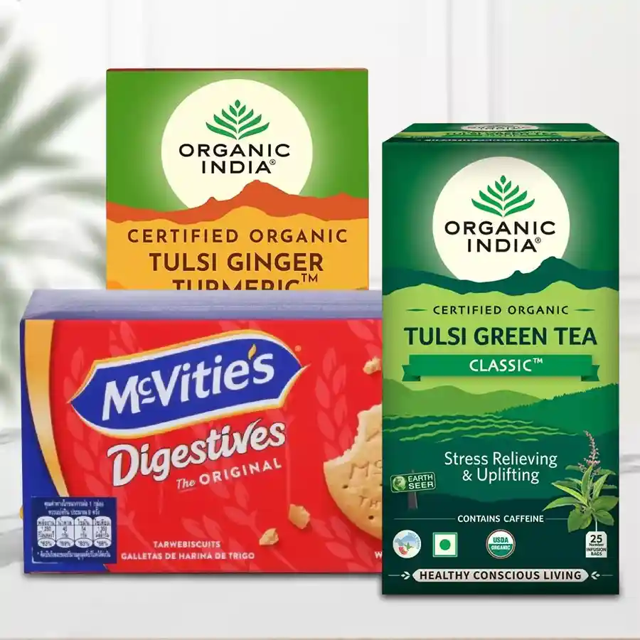 Tea Time Hamper featuring Organic India Tulsi, Ginger & Turmeric Teas, Green Tea bags, and McVitties Digestive Cookies.