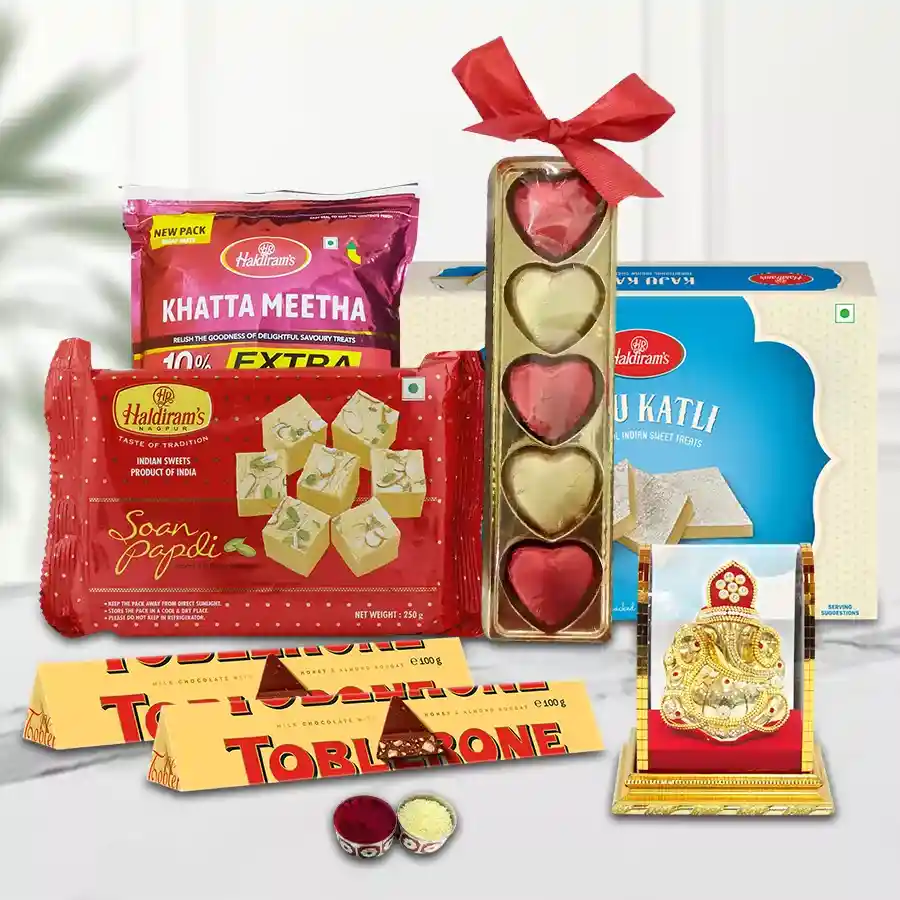 Classy Haldirams Ambrosial Assortment with sweets, chocolates, homemade treats, Roli Teeka, Chawal, and a Ganesh Idol for Bhai Dooj celebration.