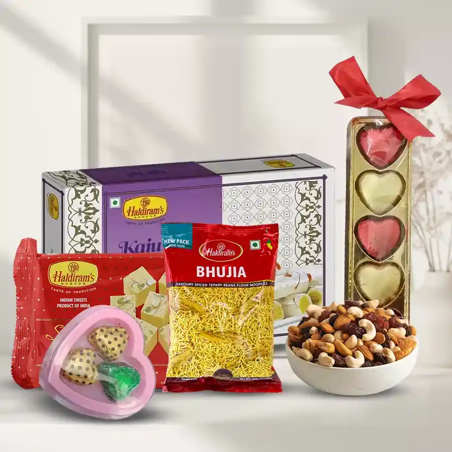 Haldiram's Fun-to-Much Ensemble featuring Soan Papdi, crispy Bhujia, Kaju Pista Rolls, assorted dry fruits, and homemade chocolates in a heart-shaped box.