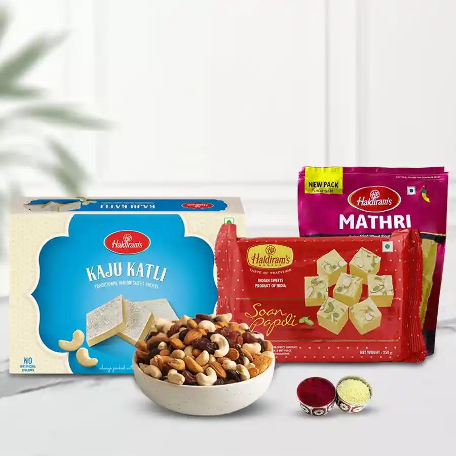 Bhai Dooj gift combo featuring assorted dry fruits, Haldiram Kaju Katli, Soan Papdi, and Methi Mathri with decorative Roli, Tika, and Chawal