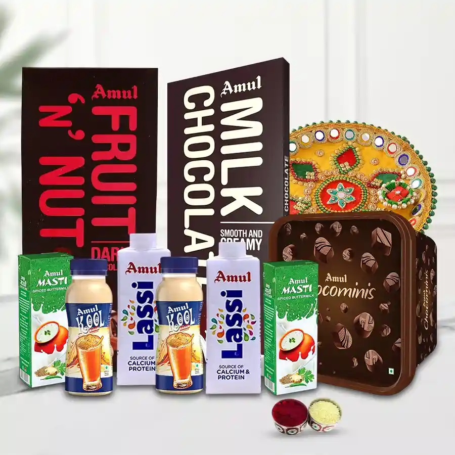 A beautifully arranged celebration hamper featuring Amul treats, a designer pooja thali, Bhai Dooj tika, and chawal, perfect for festive occasions.