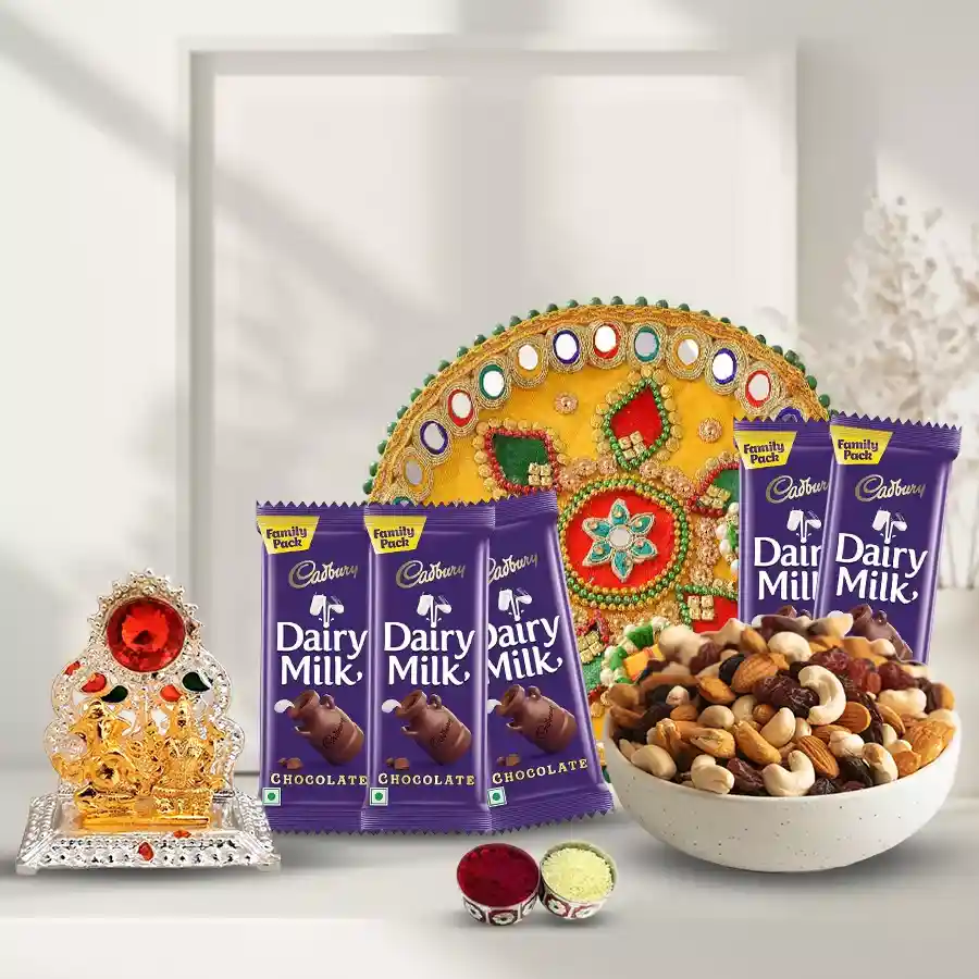 Assorted dry fruits, Cadbury Dairy Milk chocolates, a decorated pooja thali, Ganesh idol, and traditional tika and chawal for Bhai Dooj celebration.