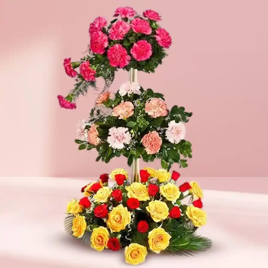 Vibrant 3-Tier Floral Delight featuring Carnations, Roses, and Mixed Blossoms in a beautiful arrangement.