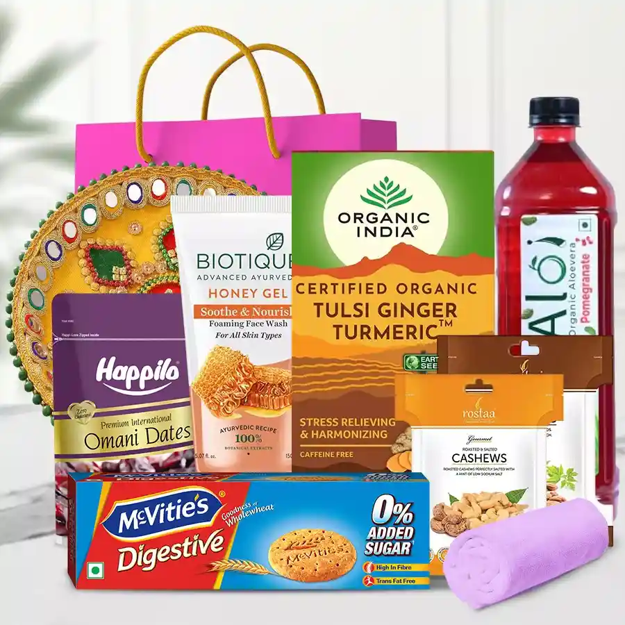 Rejuvenating Gift Hamper featuring face wash, tea, nuts, juice, cookies, dates, towel, pooja thali, and gift bag