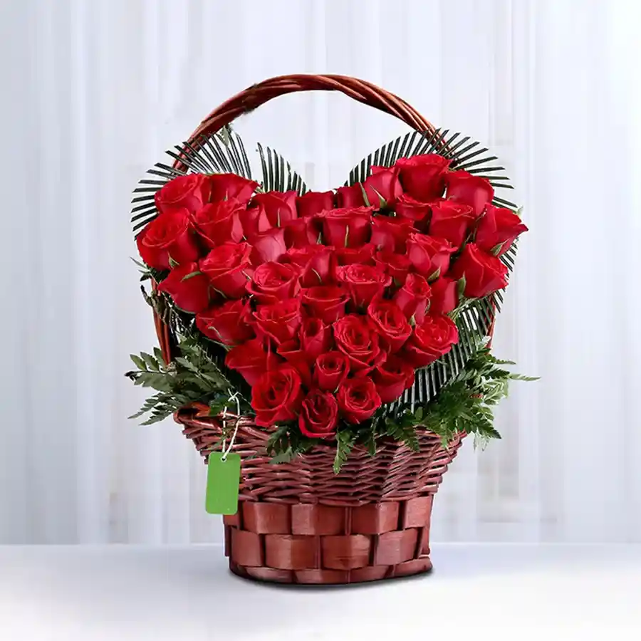 Heart-shaped arrangement of 24 vibrant red roses, ideal for expressing love.