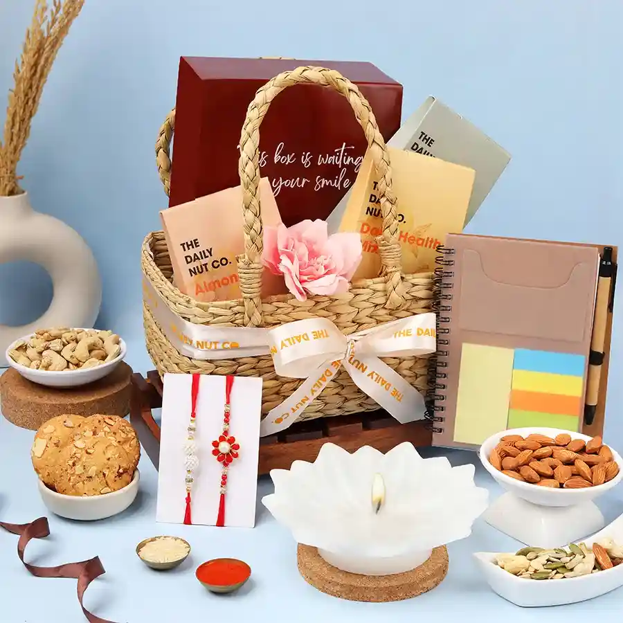 Delightful Rakhi Gift Hamper with nuts, cookies, notepad, candle, and Rakhis for celebrating the festival of Raksha Bandhan.