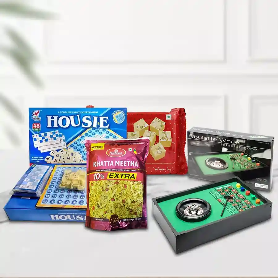 Assorted gift package featuring Haldirams Soan Papdi, Haldirams Khata Meeta, Roulle, and Housie in a decorative box