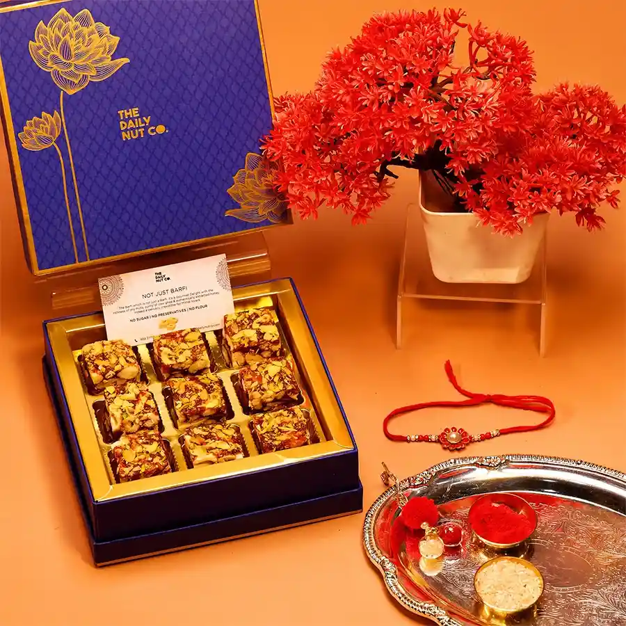 Wholesome Rakhi Special Gift Pack featuring dry fruit mithai, healthy snacks, and Rakhi in an elegant presentation.