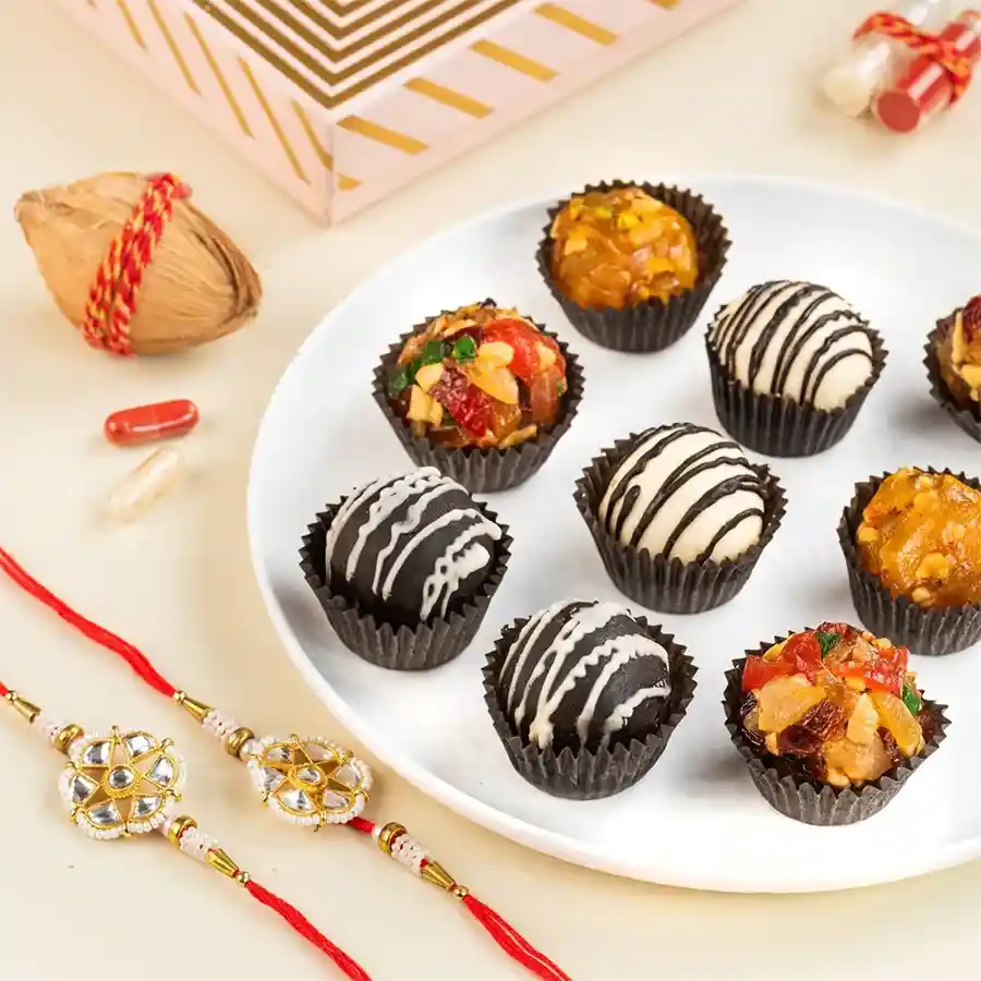 Joyful Rakhi N Fusion Laddu Gift Box with laddoos, Rakhis, and a greeting card.