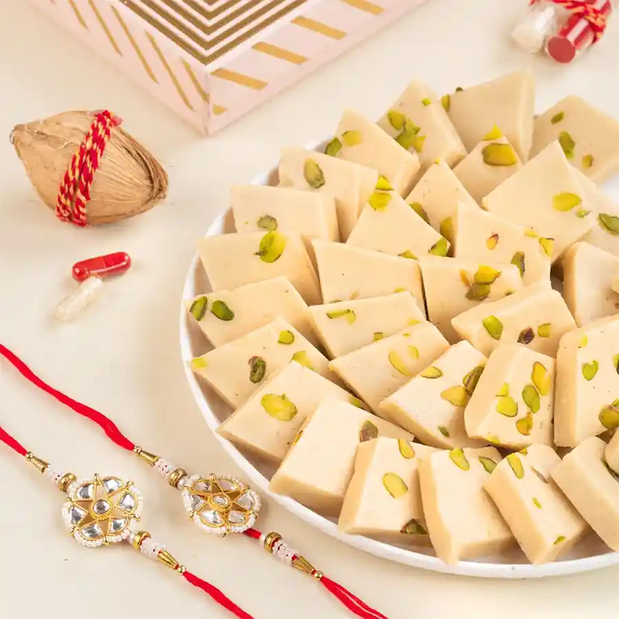 Sweet Festivities Gift Bundle with pistachio kaju katli, rakhis, and greeting card for festive celebrations.