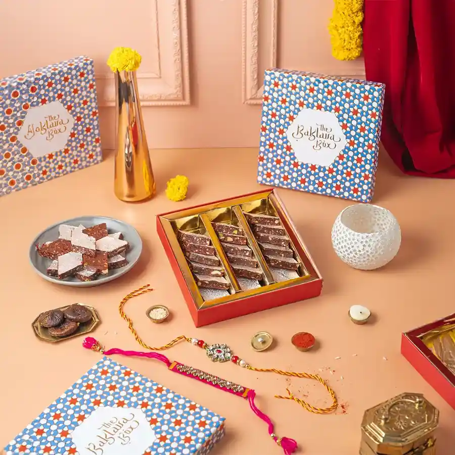 Special Anjeer Burfi & Rakhi Gift featuring sweet Anjeer Burfi and two elegant Rakhi sets.