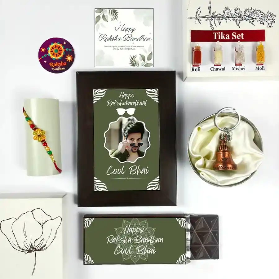 Bhai's Day Rakhi Celebration Gift Box featuring a Cool Bhai Rakhi, chocolate, photo frame, greeting card, guardian bell, and tika set.
