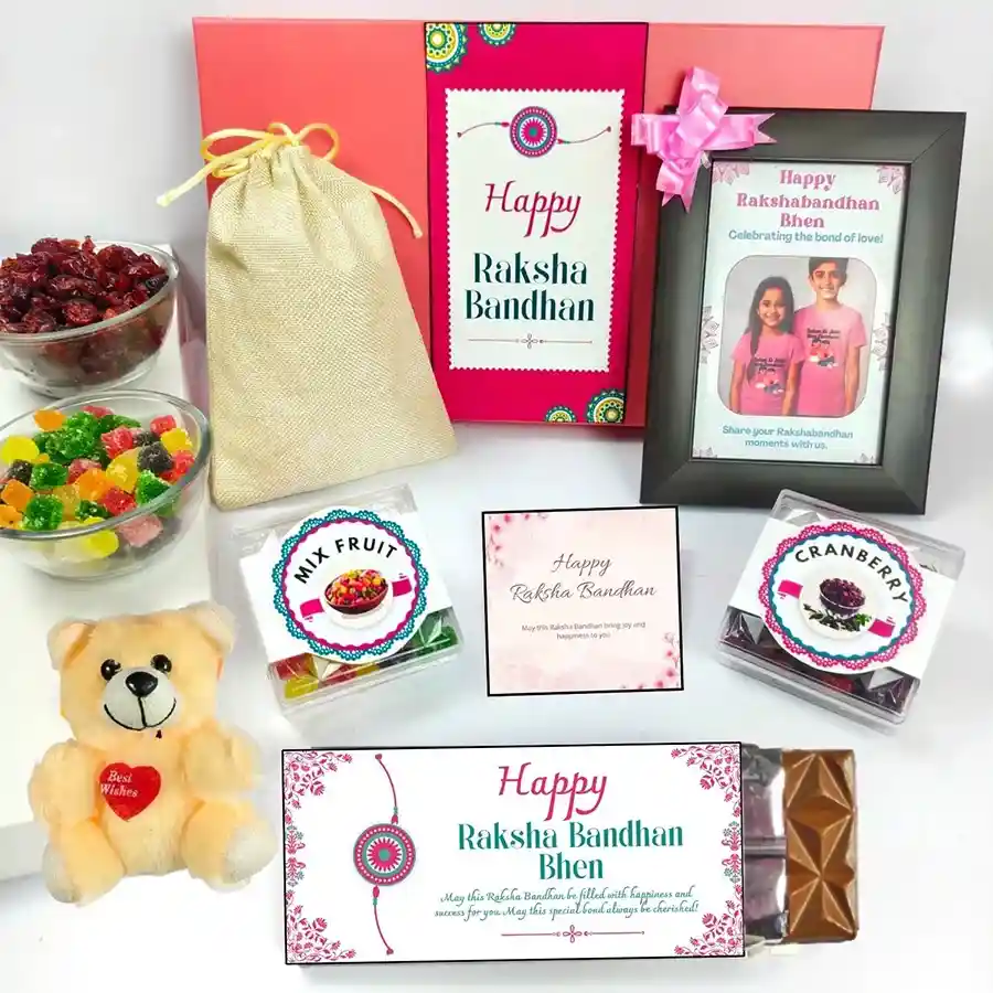 Heartfelt Rakhi Treasures Bundle, featuring chocolate, a teddy, a customized photo frame, mixed fruits, dried cranberries, and a jute potli.