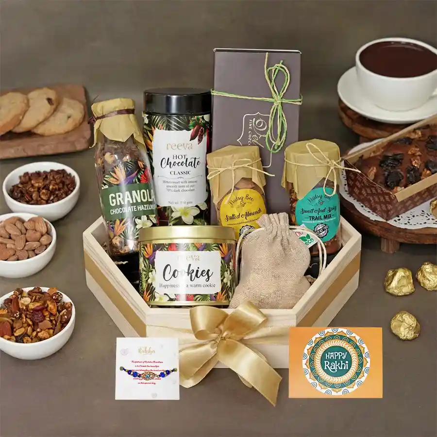 Festive Rakhi gourmet snack bundle featuring granola, cookies, and a Rakhi card for celebration.