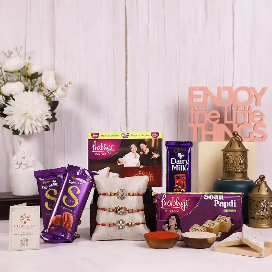 Stone Rakhi & Sweet Treats Combo featuring rakhis, Haldiram sweets, Dairy Milk chocolates, and a reusable gift box.