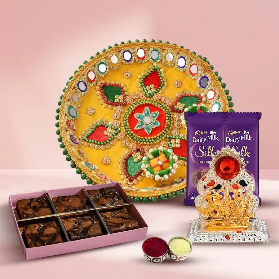 Remarkable Assortments Combo Gift for Bhai Dooj featuring a Designer Pooja Thali, Cadbury Silk bars, Dry Brownies, Ganesh Laxmi Mandap, Roli, Tika, and Chawal
