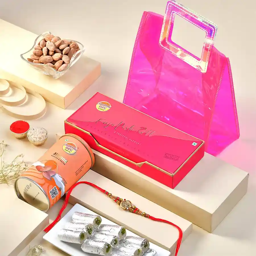 Om Rakhi & Delightful Treats Set for Rakhi season, featuring a beautiful rakhi, kaju pista rolls, and roasted salted almonds in a gift bag.