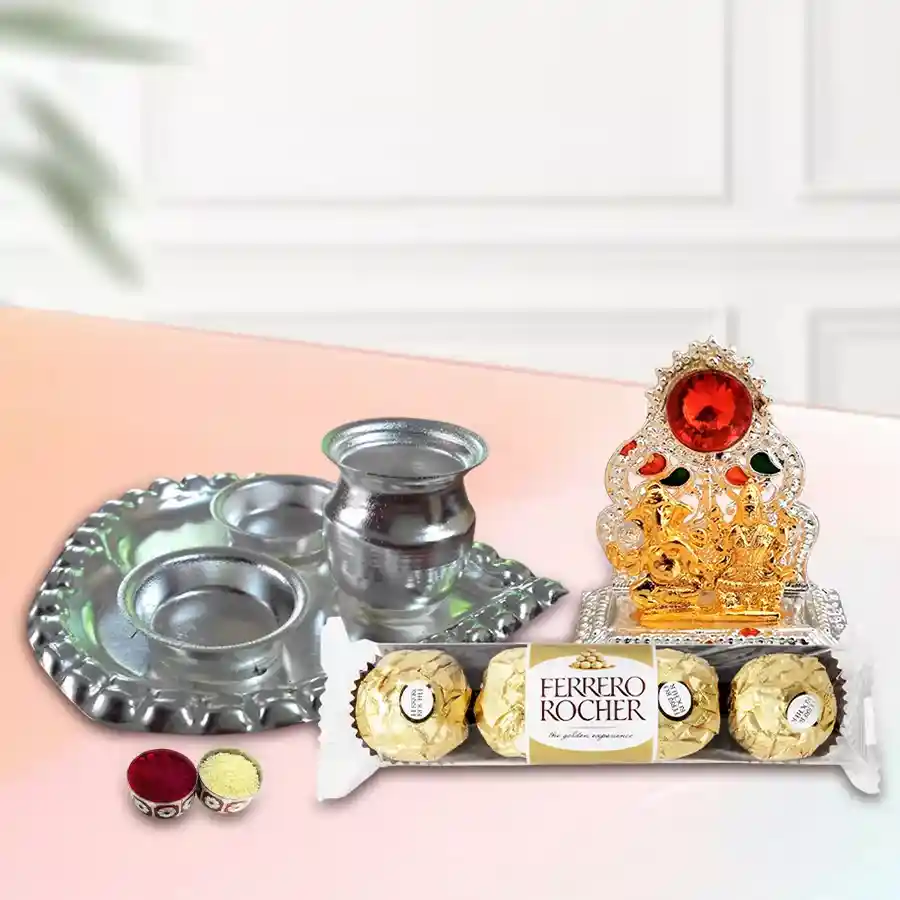 Bhai Dooj gift hamper featuring a silver-plated paan-shaped arta thali, Ganesh Laxmi mandap, Ferrero Rocher chocolates, Bhai Dooj tika, and chawal.