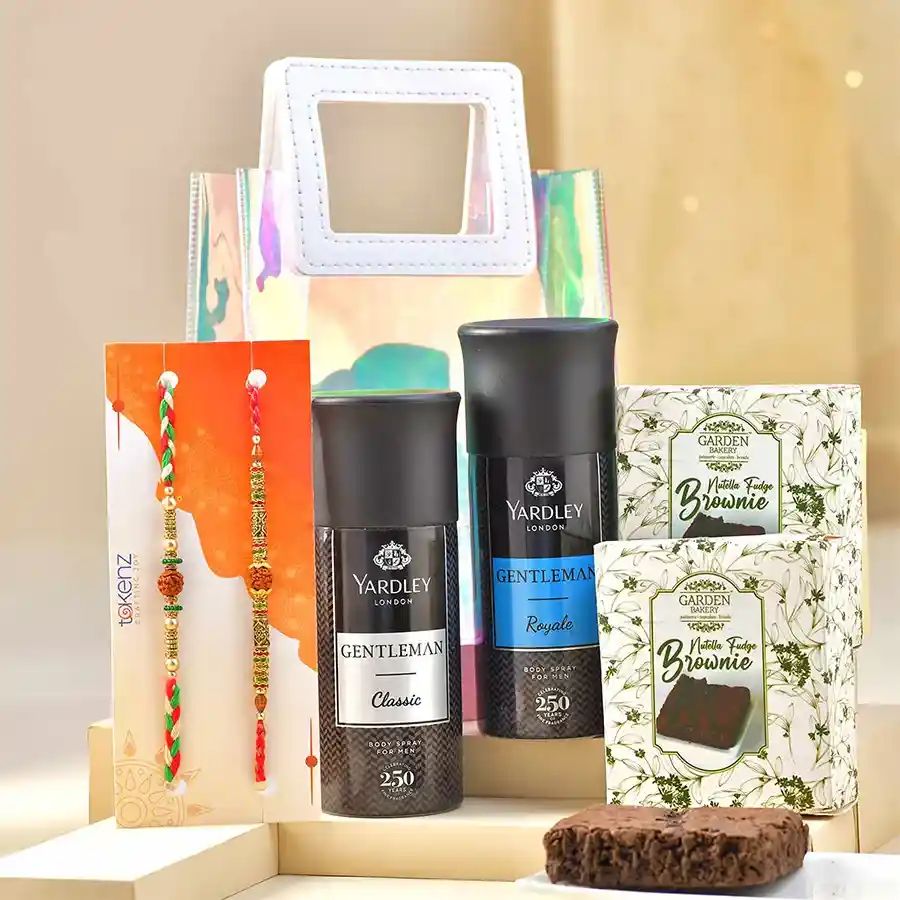 Classy Rakhi & Treats Ensemble with Rudraksh, two Yardley body sprays, Nutella brownies, and a transparent gift bag.