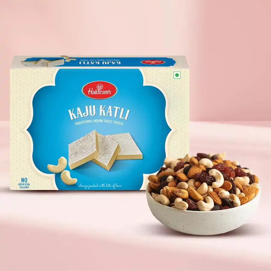 Kaju Katli and dry fruits in an elegant packaging on a decorative surface