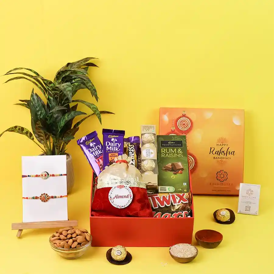 Divine Rakhi set with OM and Ganesh, chocolates, and almonds
