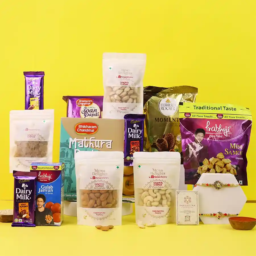 Exquisite Ganesh Rakhi gift set with sweets and nuts.