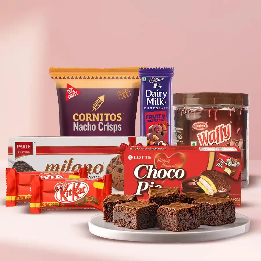 Assortment of Milano Cookies, Lotte Chocopie, Cornitos Nachos, Dry Brownies, Waffy Rolled Wafers, Nestle KitKats, and Cadbury Fruit & Nut in a gift box