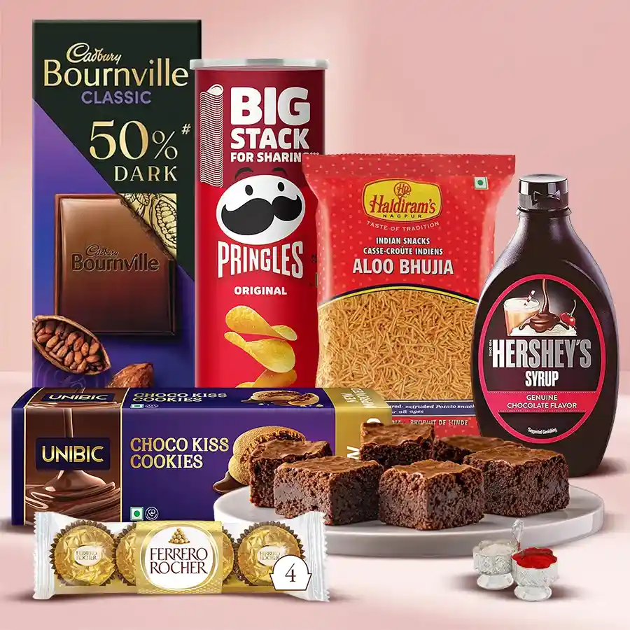 Exquisite Sweet N Savory Combo Gift featuring Unibic Choco Kiss Cookies, Pringle Chips, Ferrero Rocher, Cadbury Dark Milk, Haldirams Aloo Bhujia, delicious brownies, Hershey’s Chocolate Syrup, and festive Roli, Tika, and Chawal.