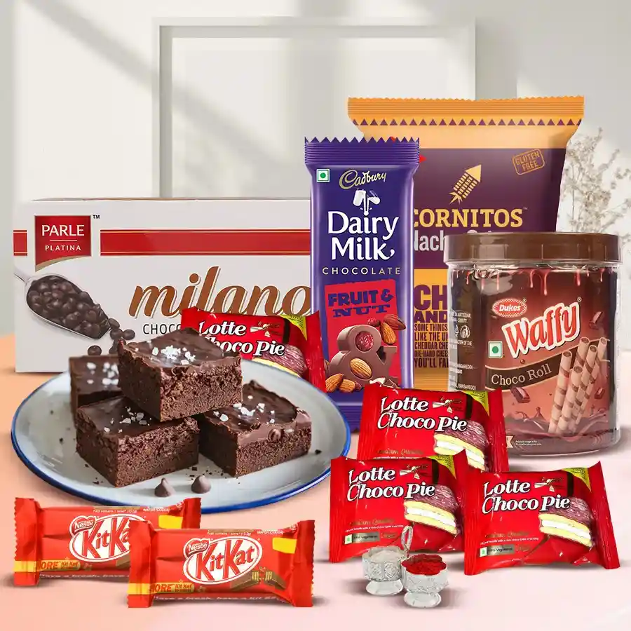Wonderful Snacks Combo Gift with Waffy Cream Filled Rolled Wafers, Cadbury Fruit 'n Nut, KitKat bars, Lotte Chocopie, Cornitos Nachos, Milano Cookies, Dry Brownies, and complimentary Roli, Tika, and Chawal for Bhai Dooj celebration.