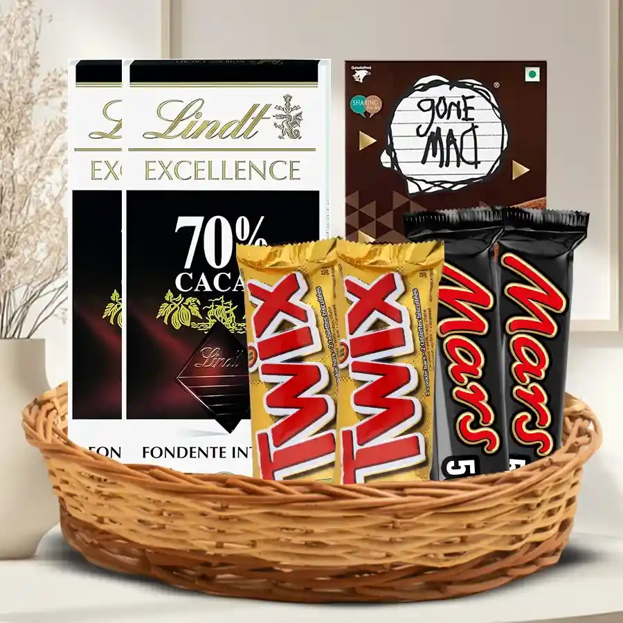 Delightful Gift Hamper filled with assorted chocolates including Lindt Excellence bars, Snickers, Twix, Mars bars, and Gone Mad Chocolate bars in a charming basket.