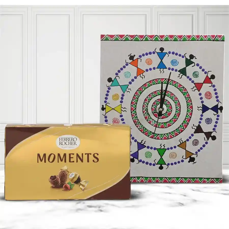 Designer Warli Art Wall Clock alongside a box of Ferrero Rocher chocolates