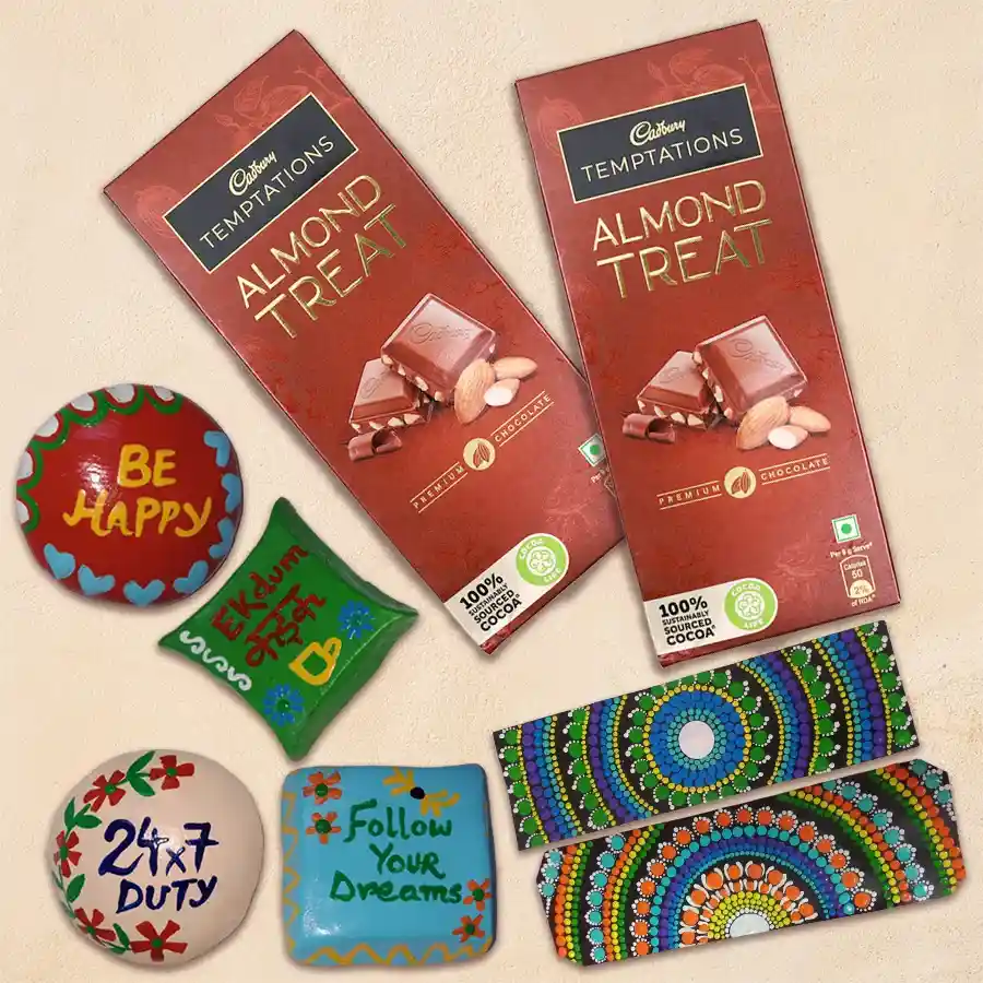 Irresistible Cadbury chocolates with a Dot Mandala Art Book Marker and handmade fridge magnets arranged on a decorative background.