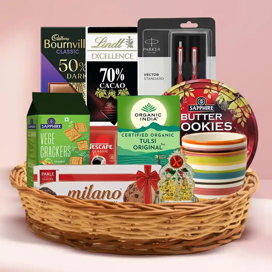 Exclusive Diwali hamper featuring chocolates, cookies, tea, coffee, a coffee mug, Ganesh-Laxmi Mandap, a pen set, and a cane basket