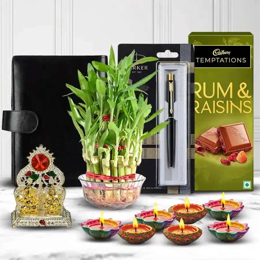 Eco Friendly Diwali Gift Combo featuring a stylish planner diary, Parker Beta pen, Cadbury Bournville Raisins & Nuts, Double Deck Lucky Bamboo Plant, elegant Ganesh Laxmi Mandap, and six beautifully decorated diyas.