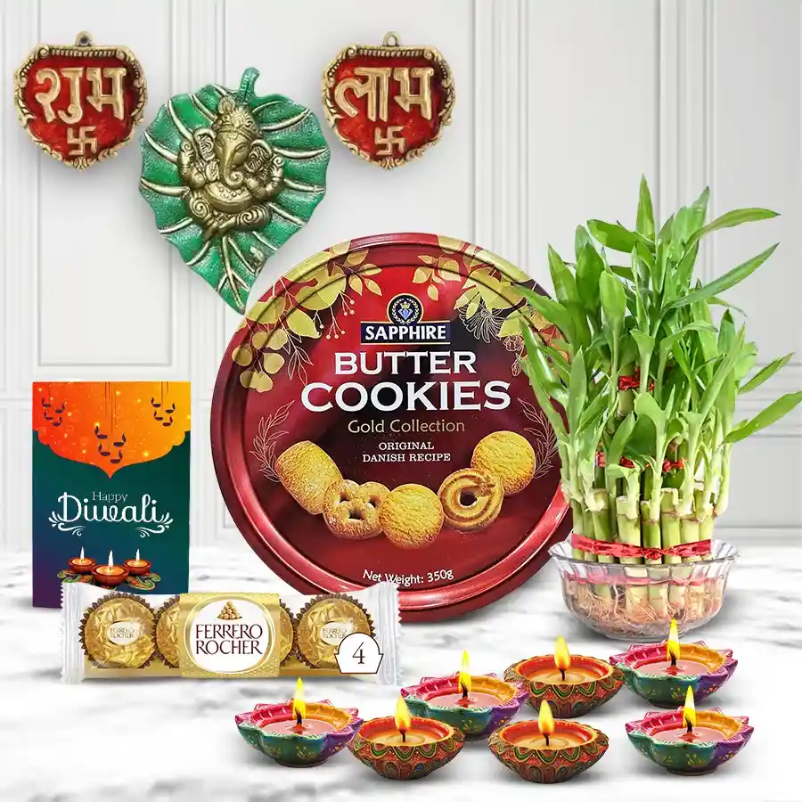 Diwali gift hamper featuring Sapphire Butter Cookies, Ferrero Rocher chocolates, mud diyas, metallic Ganesha and Subh Labh wall hangings, lucky bamboo plant, and a Diwali card