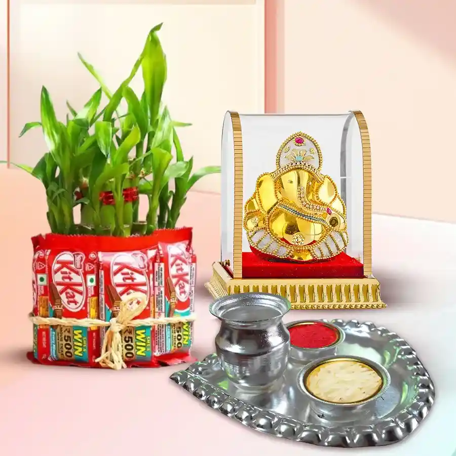 Bamboo plant, KitKat chocolates, Ganesh idol, and silver-plated Pooja Thali arranged as a festive gift hamper