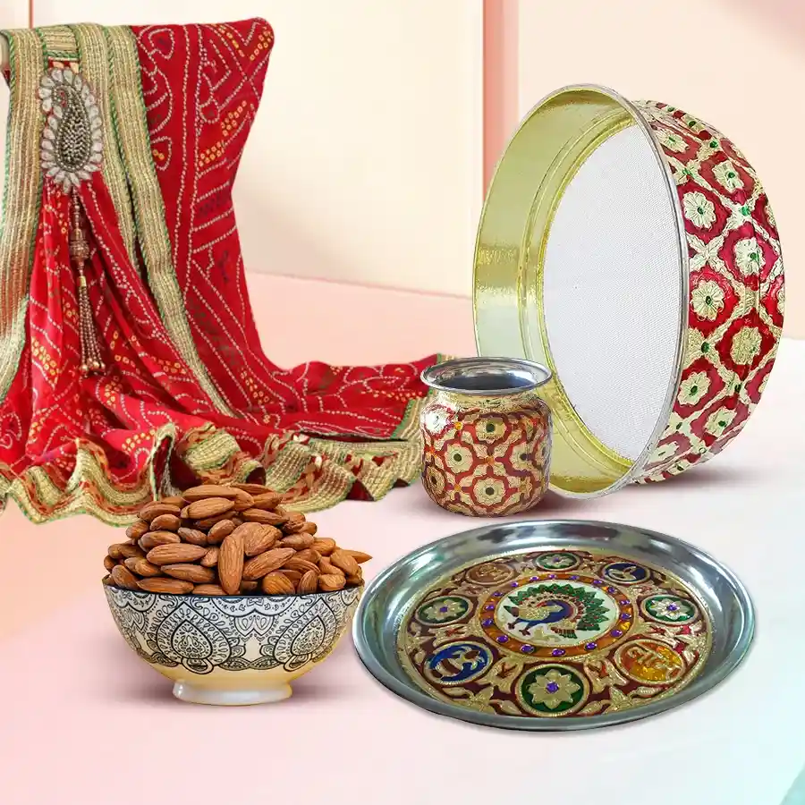 Marvelous Karwa Chauth Sargi hamper featuring a Meenakari Pooja Thali, Decorative Chalni, Designer Karwa Kalash, Bandhani Dupatta with Gota and Zari prints, and 100g of premium almonds