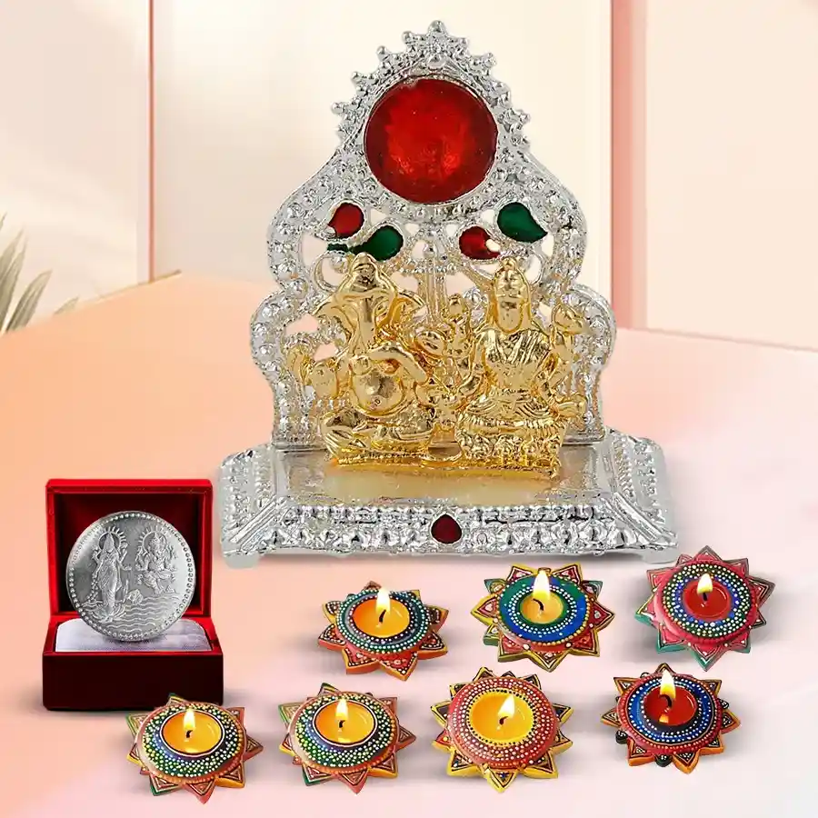 Decorative Diwali gift set featuring 7 handcrafted dot mandala art diyas, a Ganesh Lakshmi mandap, and a silver-plated coin on a festive background.