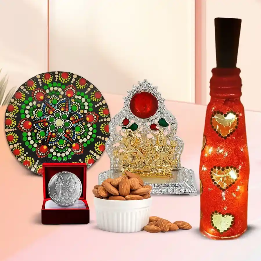 Exclusive Diwali gift set featuring Antique Laxmi Ganesh Mandap, fresh almonds in a potli, handcrafted rangoli art, LED bottle lamp, and a silver-plated Laxmi Ganesh coin.