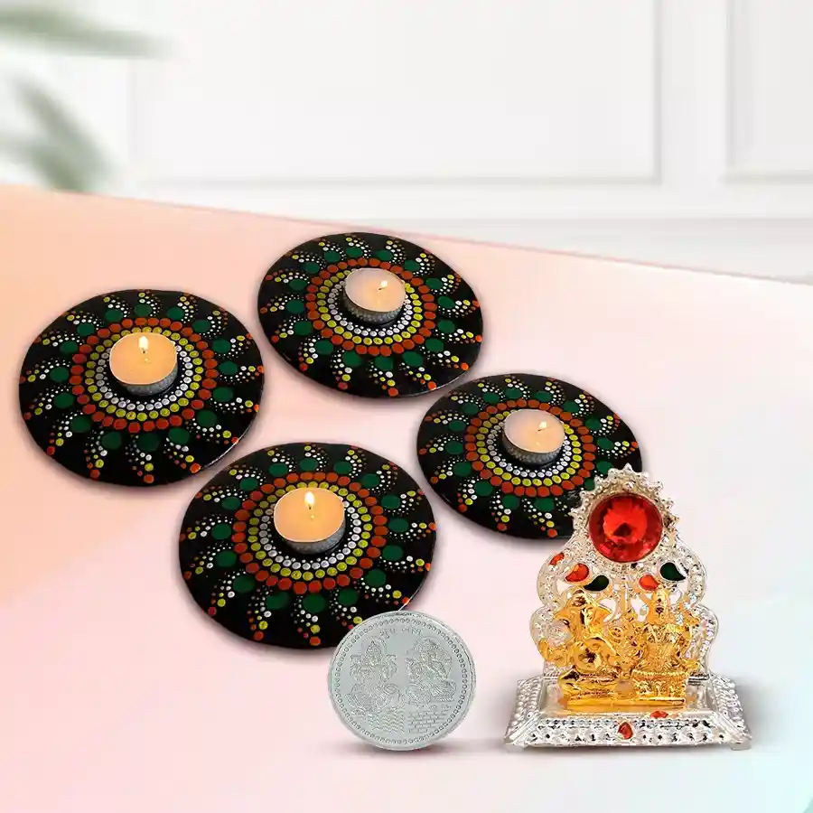 Propitious Ganesh Laxmi Mandap set with Rangoli decor, candles, and silver coin for Diwali celebrations