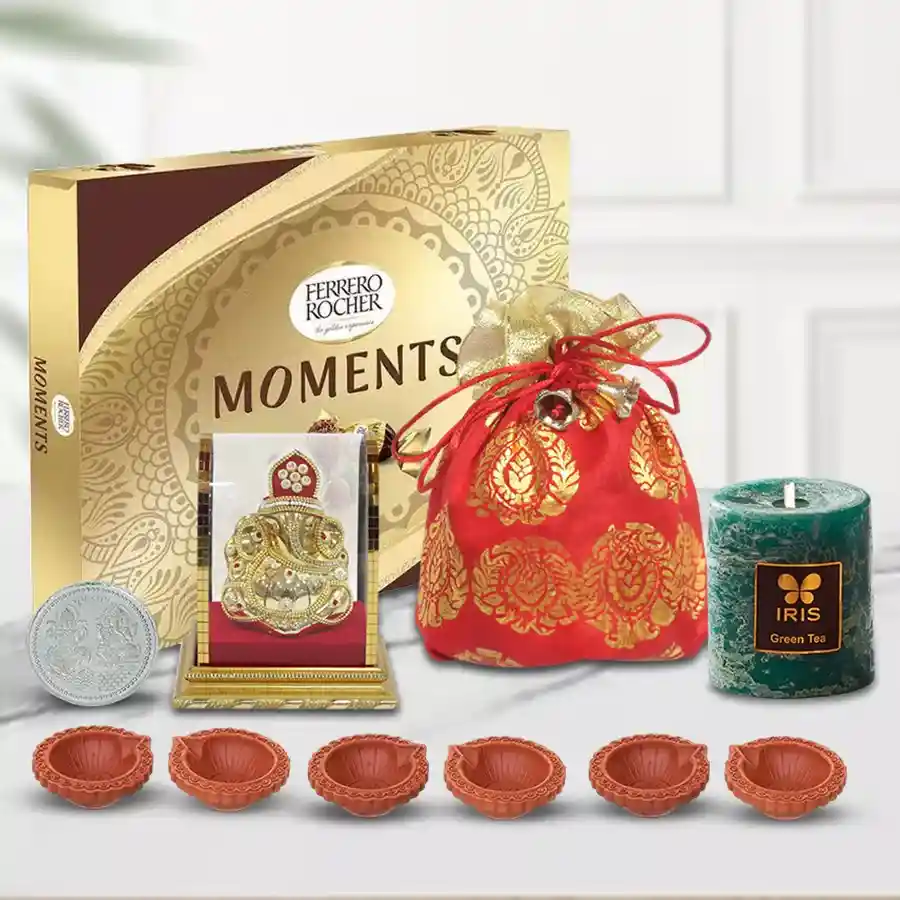 Ferrero Rocher chocolates, dry fruits, Ganesh idol, aroma candle, and decorative diyas arranged in a festive gift hamper for Diwali celebration.